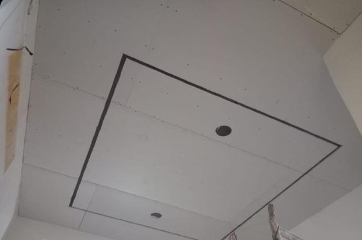 A false ceiling frame mid-installation